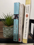 Three used historical fiction paperbacks: The Time Traveler’s Wife, Between Shades of Gray, and We Were the Lucky Ones
